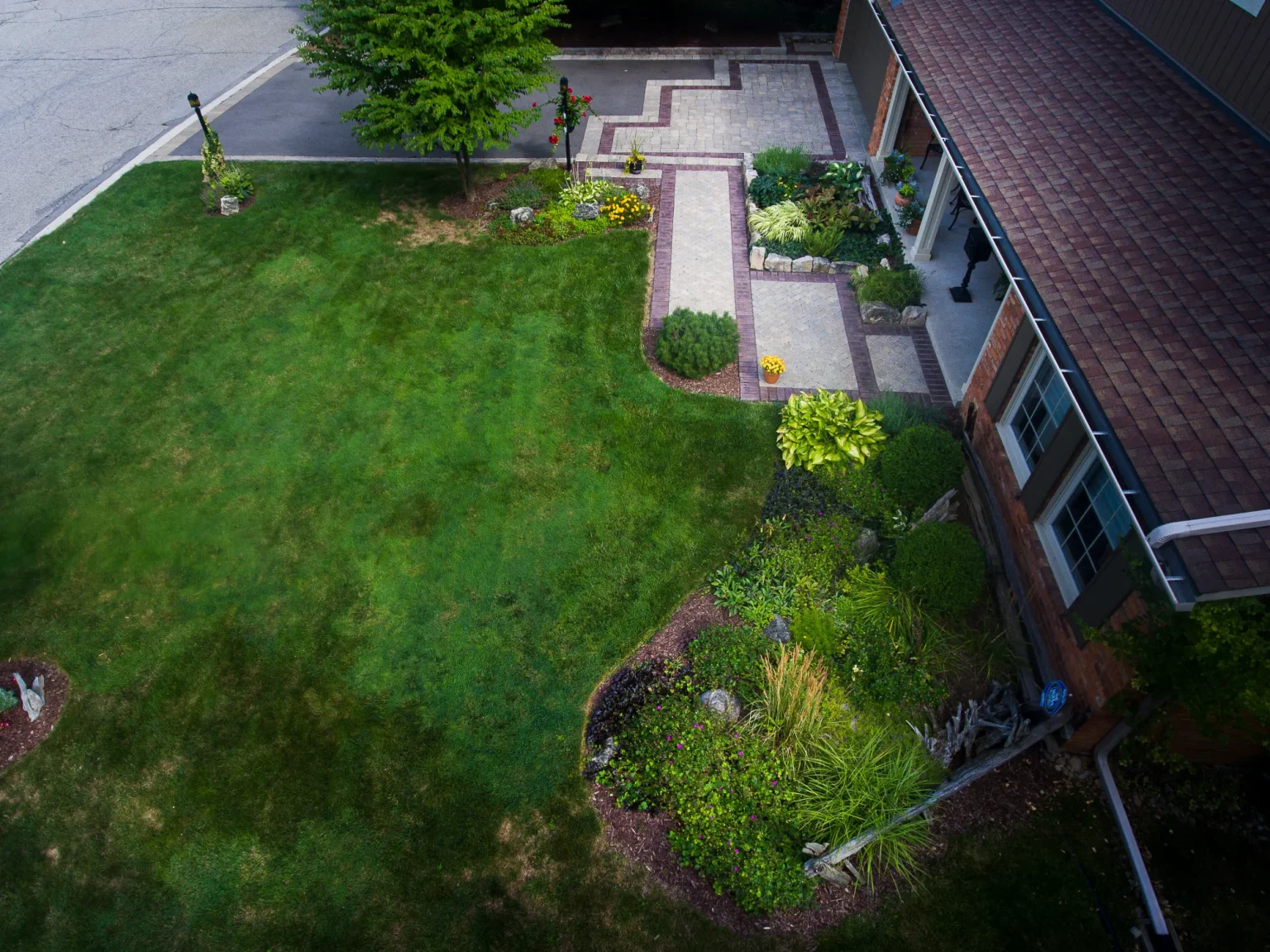 Aerial establishing view of the front lawn, interlock walkway and landscaped beds in Ancaster.