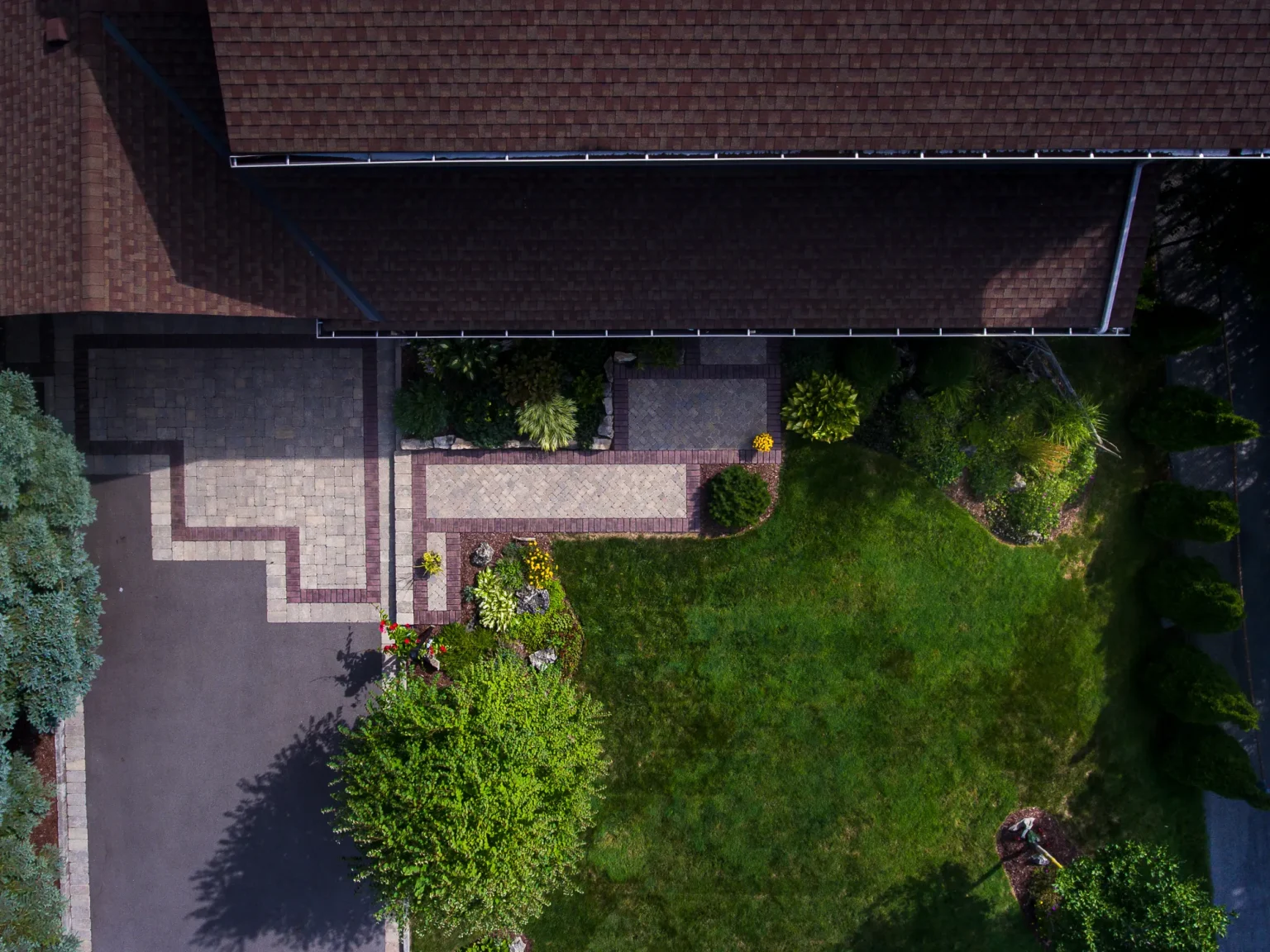 Direct overhead detail of the walkway, driveway edge and planting-bed geometry in Ancaster.
