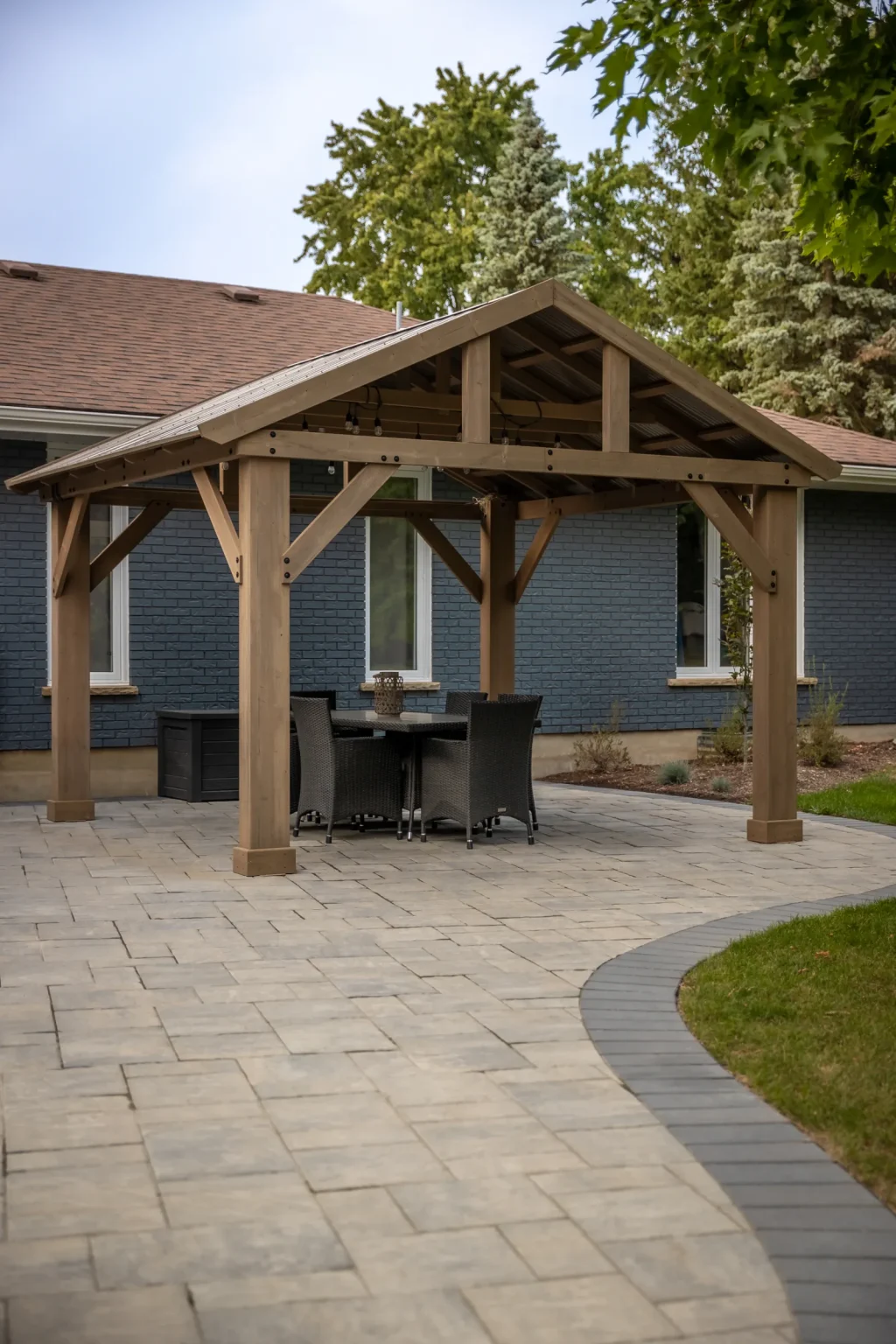 Timber pergola over an interlock backyard patio in Brantford.
