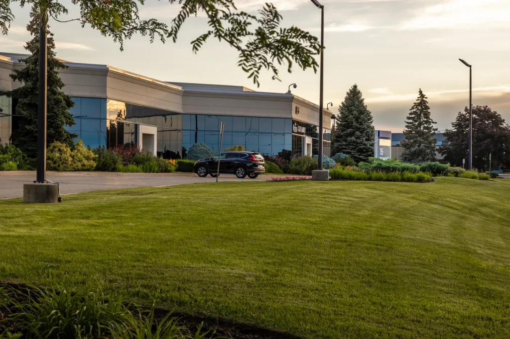Maintained commercial lawn and office landscaping in warm evening light.