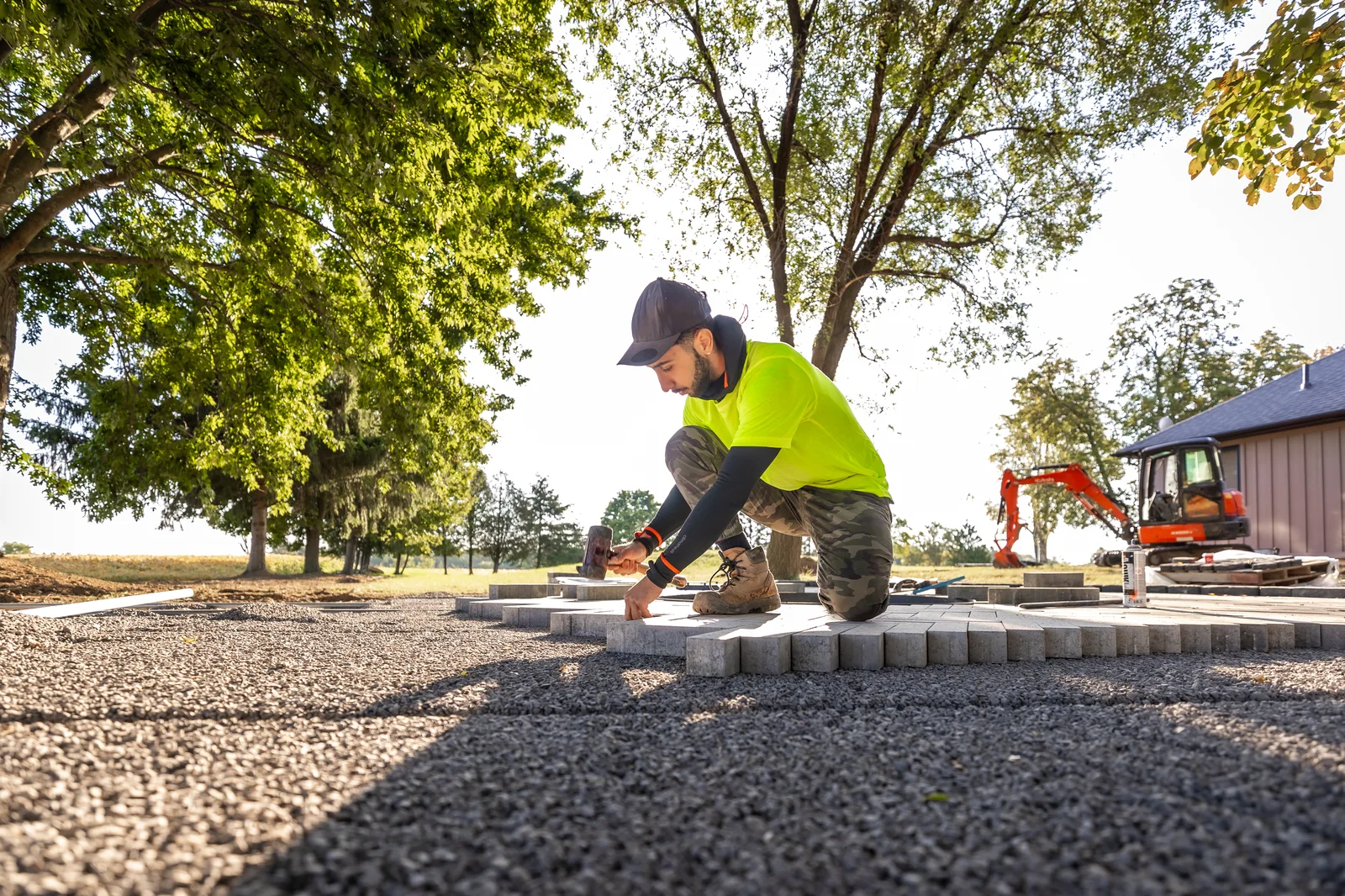 Creative Concepts crew member installing concrete pavers.