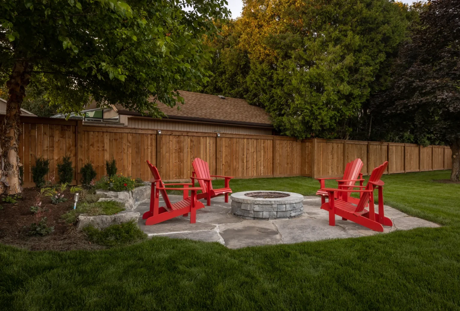Wide view of a backyard fire pit and seating area in Dundas.