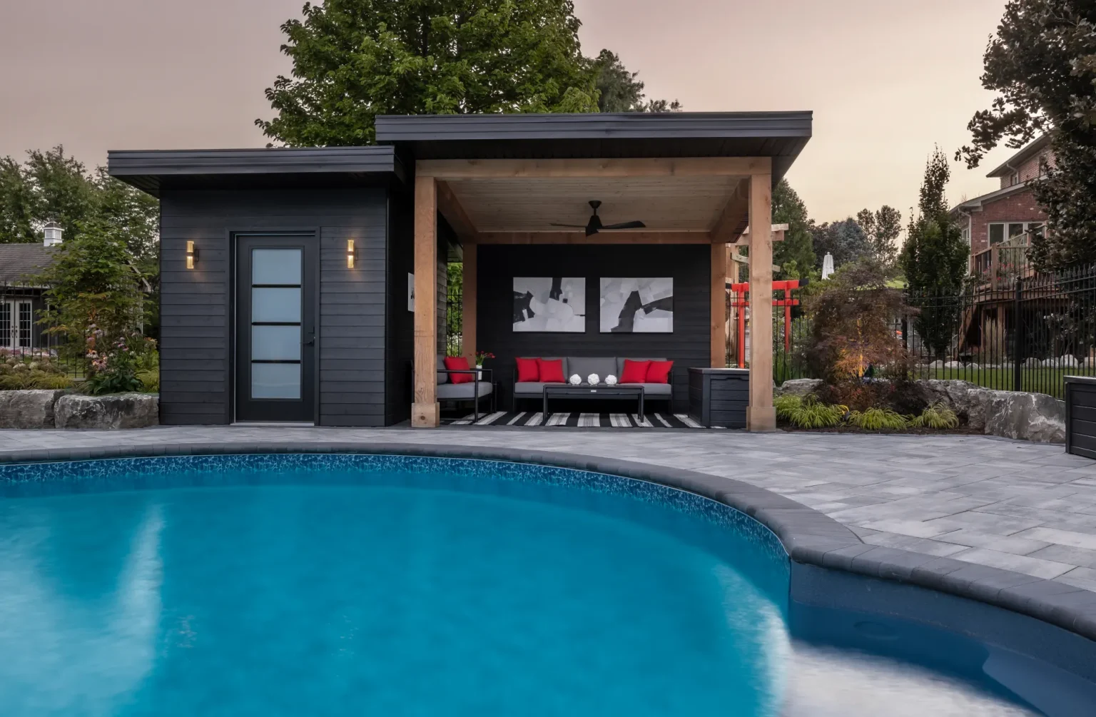 Blue-hour pool view toward the contemporary cabana in Dundas.