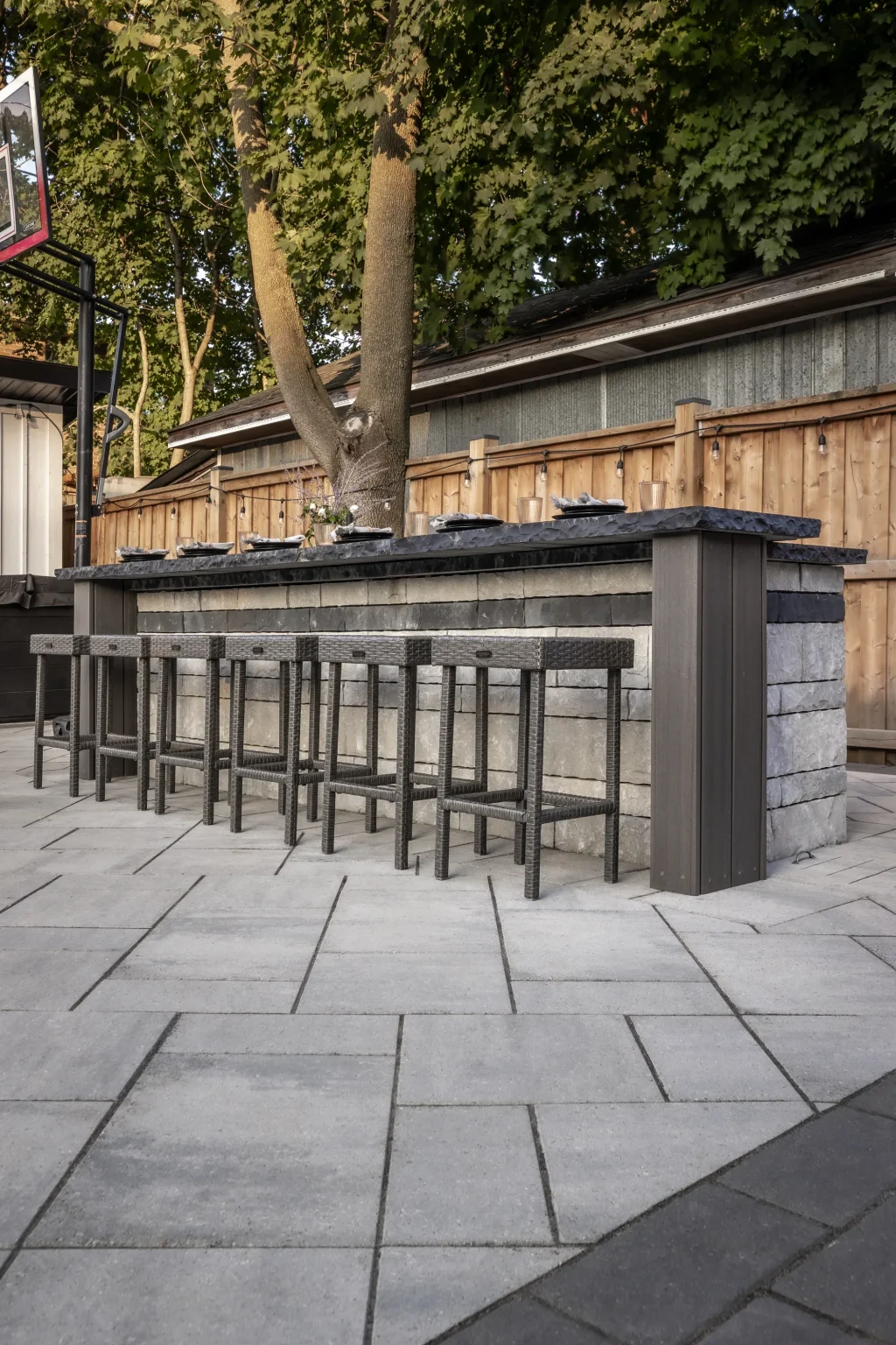 Portrait view of the built-in outdoor bar and modern paver patio in Dundas.
