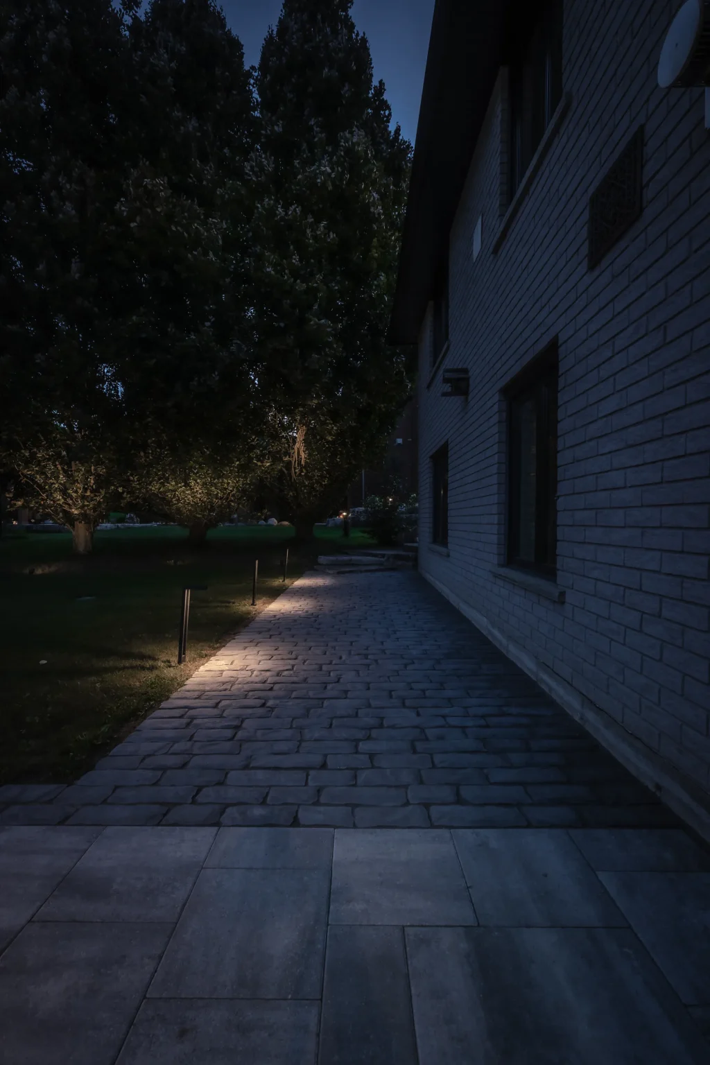 Night path along the house with low landscape lighting in Dundas.