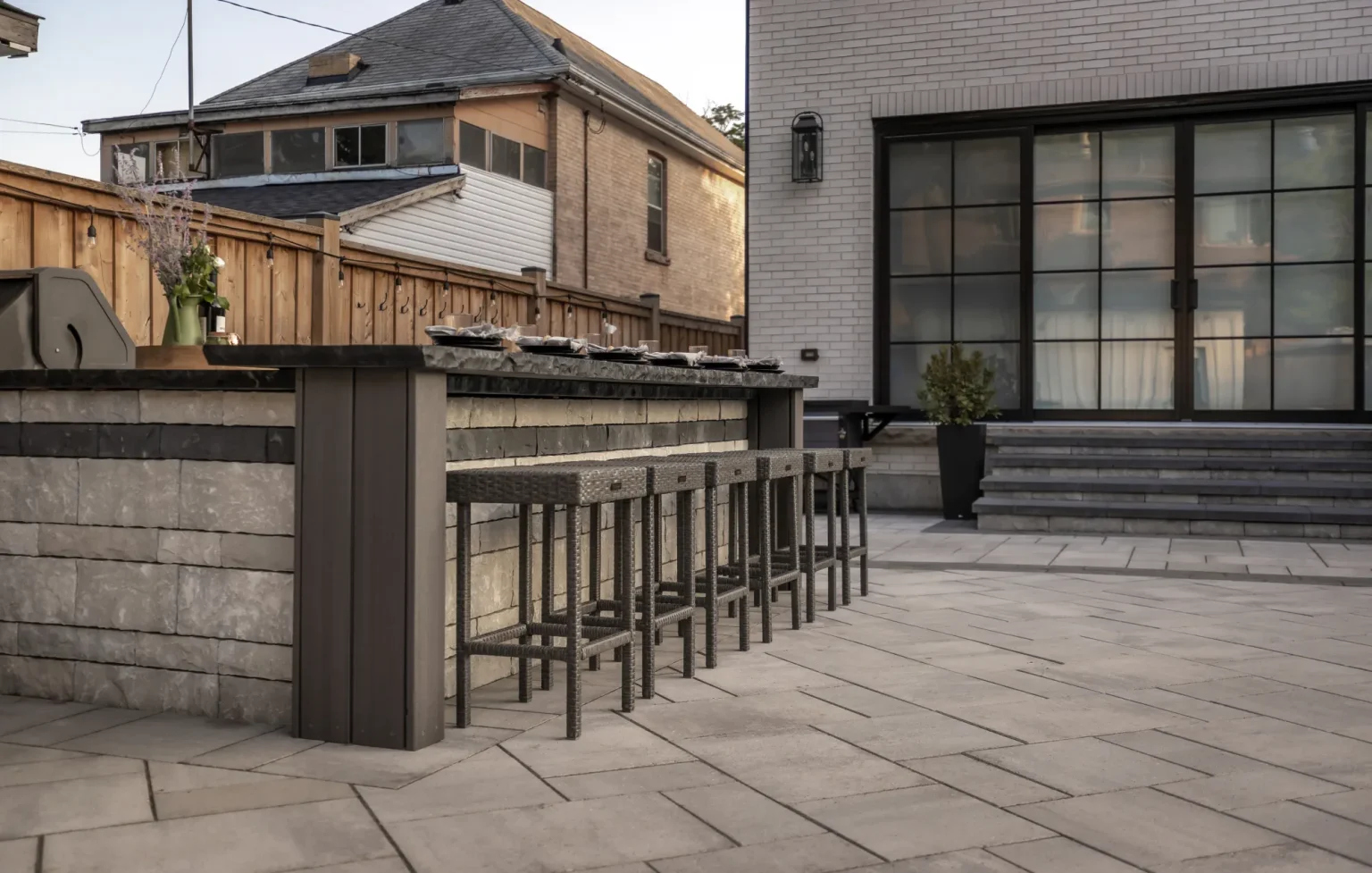 Outdoor bar and rear steps viewed together across the finished paver patio in Dundas.