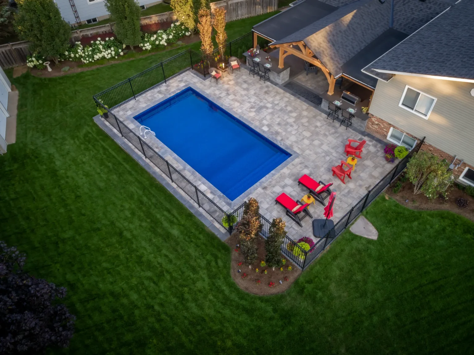 Oblique aerial photograph of the Dundas pool, stone patio and timber-framed house extension.
