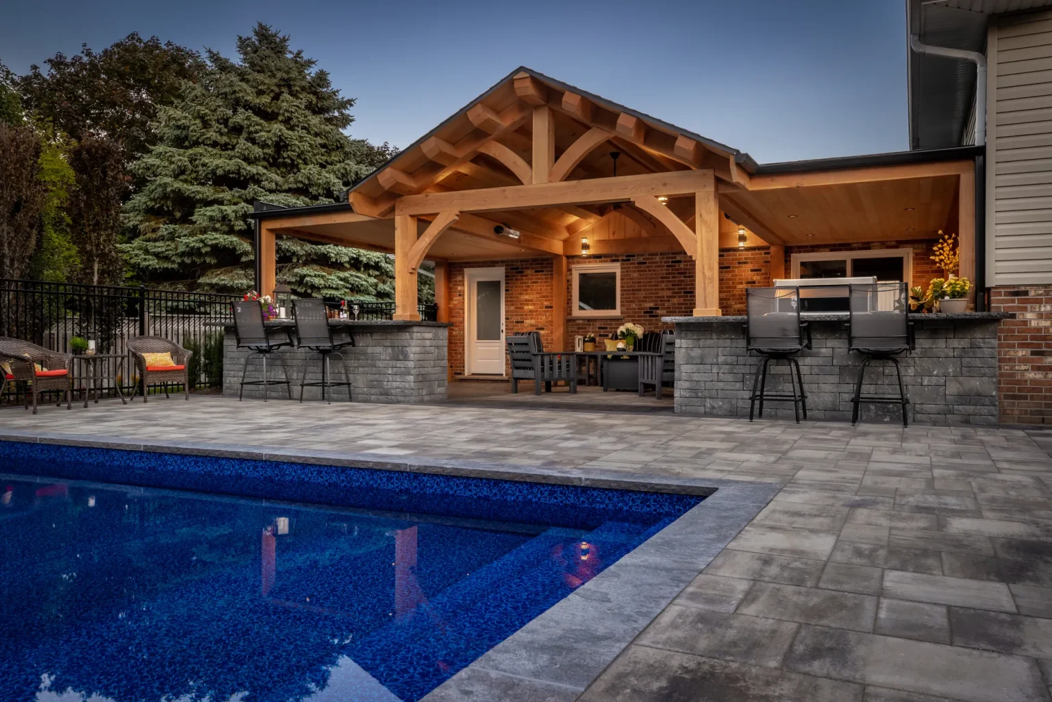 Pool patio and covered outdoor bar attached to the Dundas home.