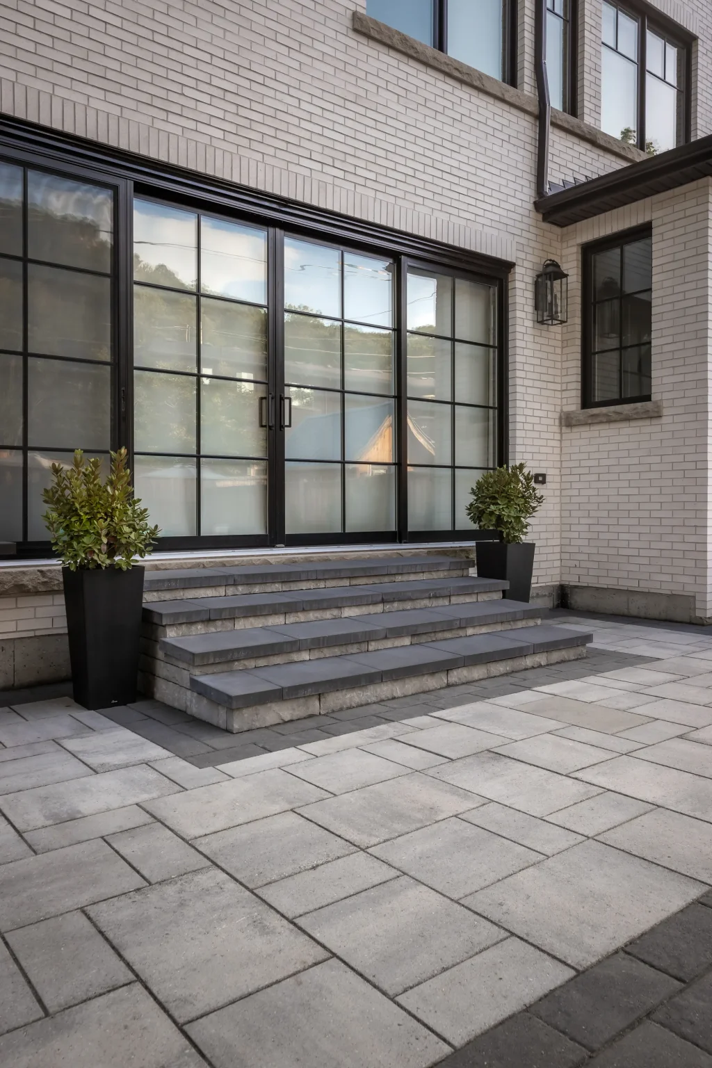 Portrait rear-entry view showing modern steps and patio beside the pool in Dundas.