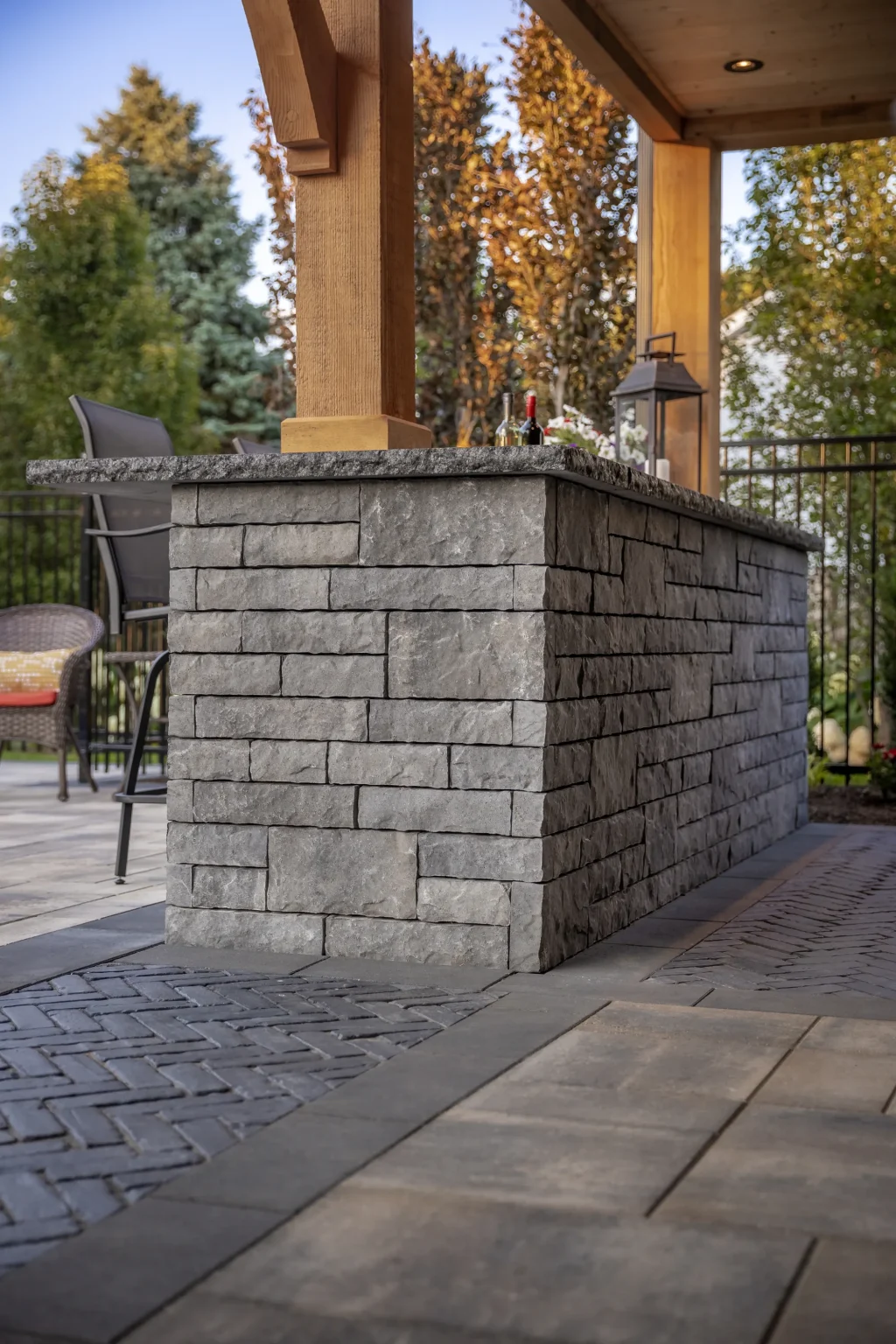 Stone-clad outdoor bar beneath the timber-framed house extension in Dundas.