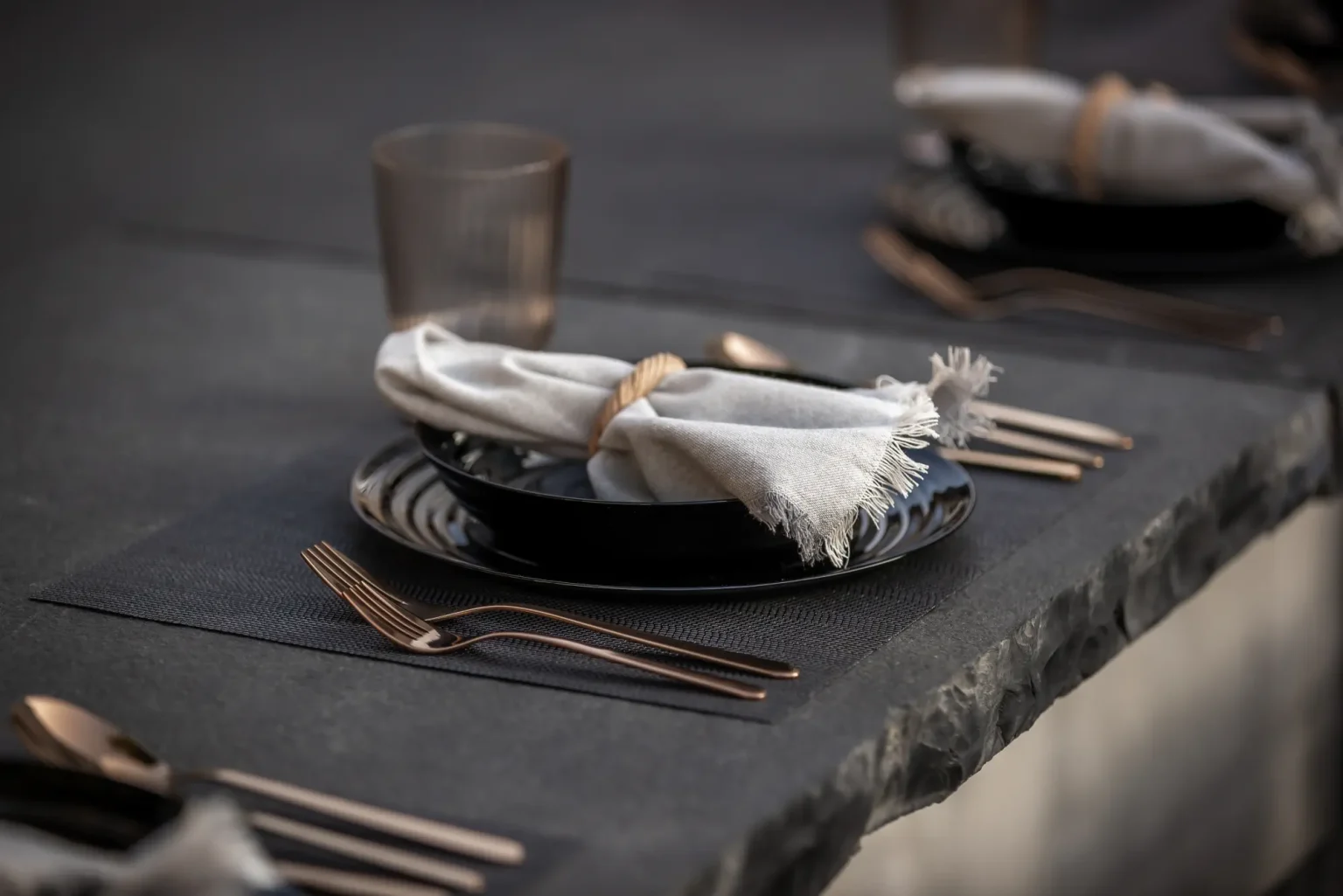 Second styled dining place setting on the dark outdoor counter in Dundas.