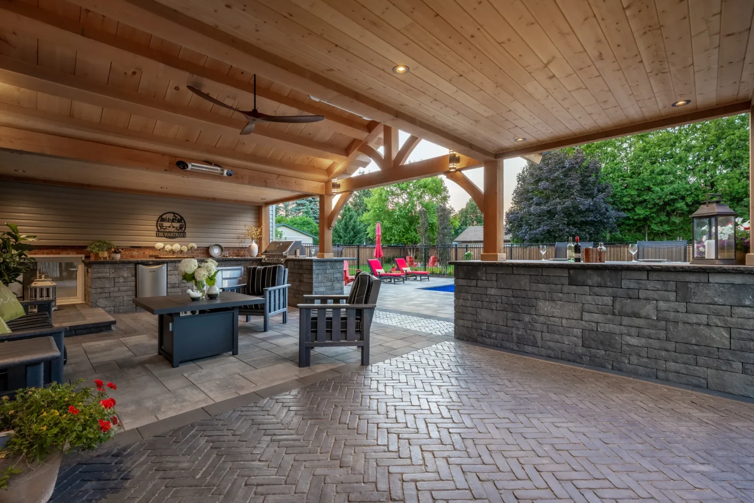 Covered outdoor kitchen, bar and seating beneath the timber-framed house extension in Dundas.