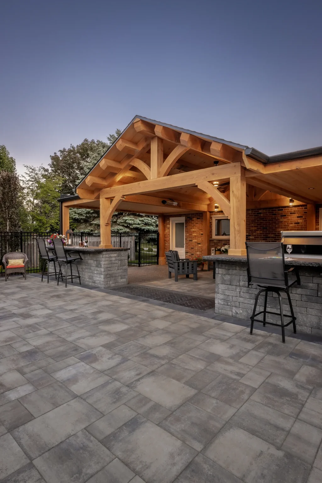 Portrait view of the gabled timber frame, flat side roofs and outdoor bar beside the Dundas home.