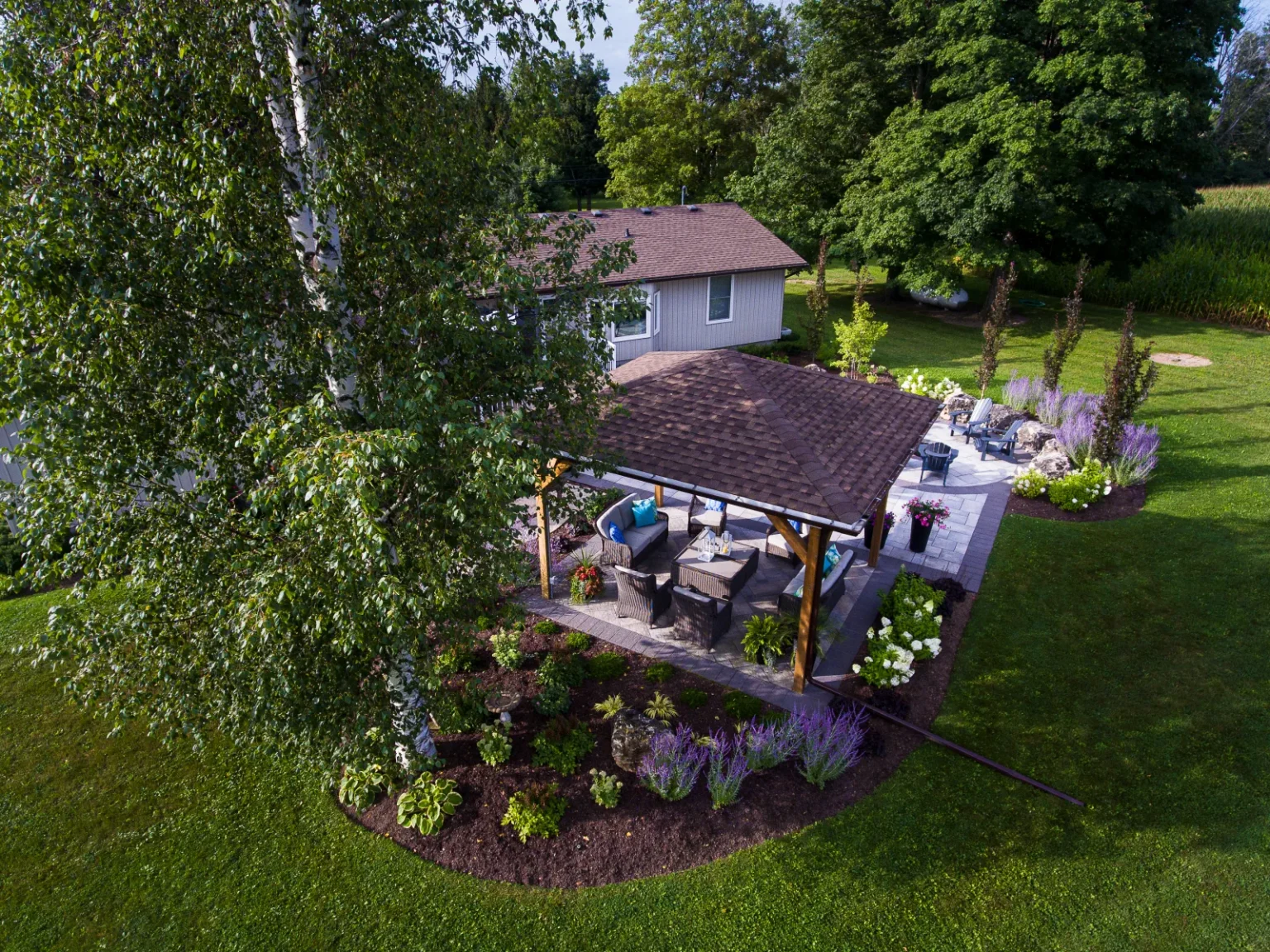 Aerial view of the backyard pavilion, circular fire-pit patio and surrounding gardens in Flamborough.
