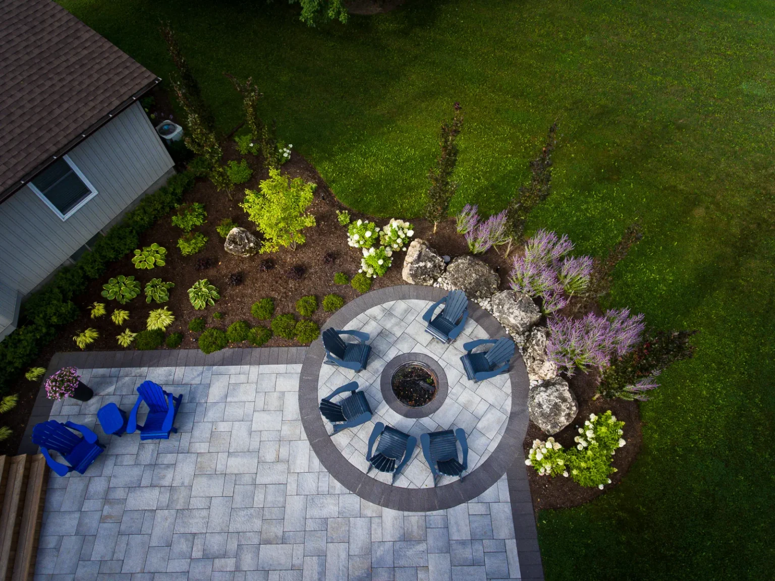 Top-down aerial detail of the circular fire-pit seating area and planting beds in Flamborough.