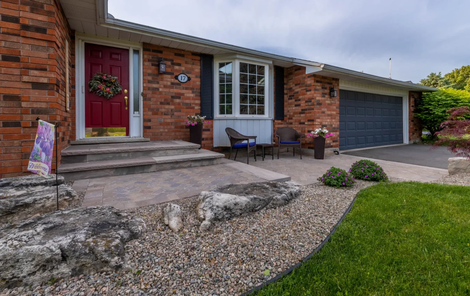 Completed front entry with natural stone steps, paver walkway and stone edging in Flamborough.
