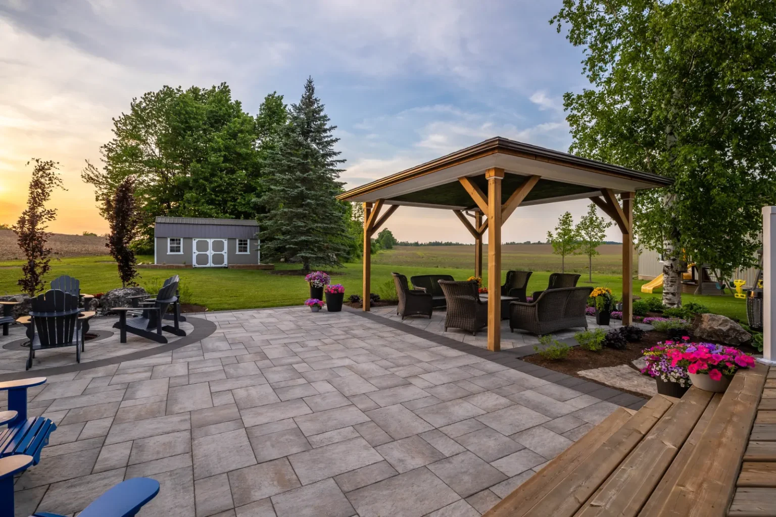 Wide view of the pavilion and expansive paver patio at sunset in Flamborough.