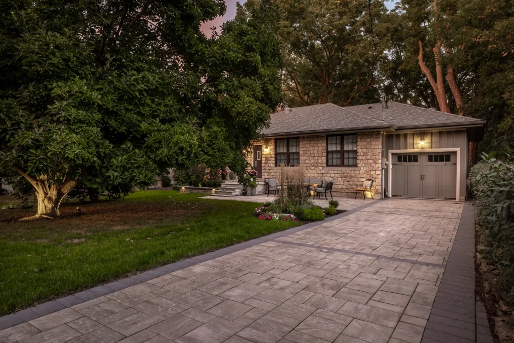 Wide establishing view of the large-format interlock driveway leading to the garage in Hamilton.